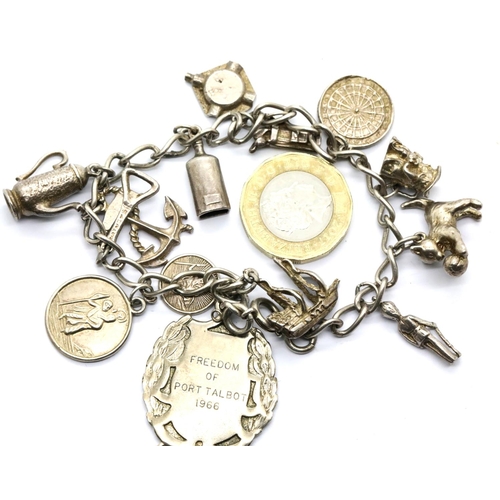 1008 - Silver charm bracelet with 14 charms, 48g. P&P Group 1 (£14+VAT for the first lot and £1+VAT for sub... 