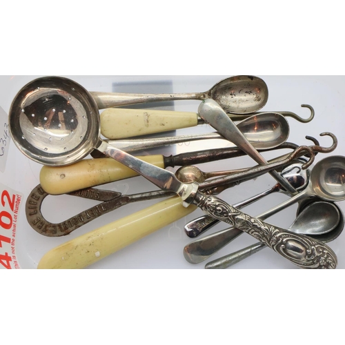 1171 - Container of condiment spoons, shoe and corset lacing hooks and silver handled spoon sifter. P&P Gro... 