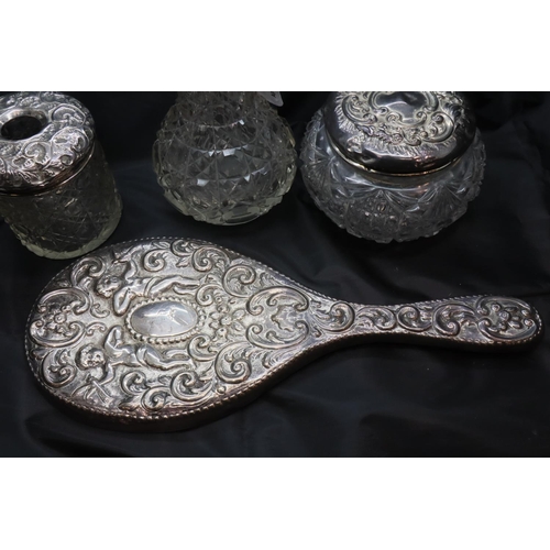 100 - Hallmarked silver dressing table hand mirror, two silver lidded pots and a perfume bottle, mixed ass... 