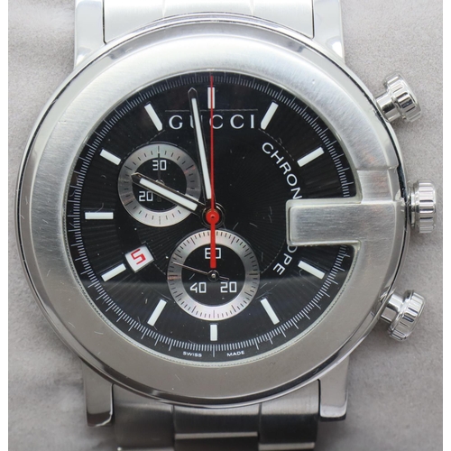 65 - Gents Gucci chronograph wristwatch, having a black dial, stainless steel body and bracelet in origin... 