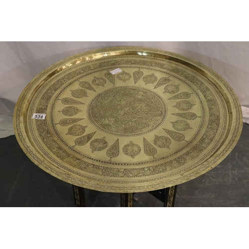 534 - Early 20thC Middle Eastern brass top table, folding base inlaid with ivory, top D: 70 cm. Not availa... 