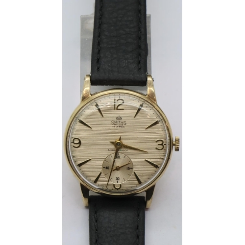 67 - Smiths Deluxe fifteen jewel 9ct gold wristwatch on a leather strap with British Rail 45 years servic... 