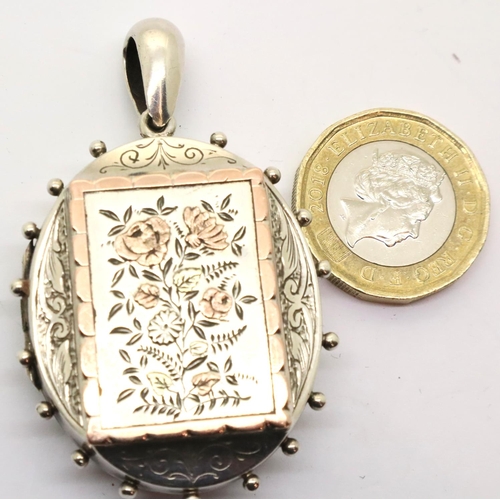 98 - Victorian mourning locket in silver with a gold washed panel of flora to the front. P&P Group 1 (£14... 