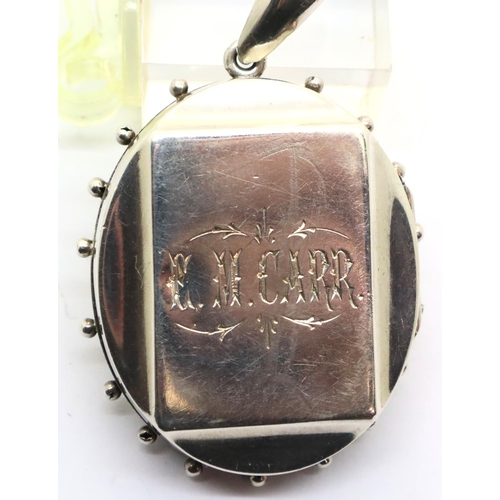 98 - Victorian mourning locket in silver with a gold washed panel of flora to the front. P&P Group 1 (£14... 