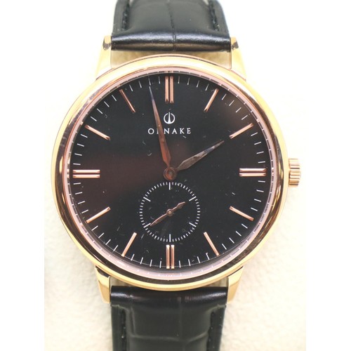 132 - New and boxed black face gold tone Ornake wristwatch with seconds dial and leather strap. P&P Group ... 