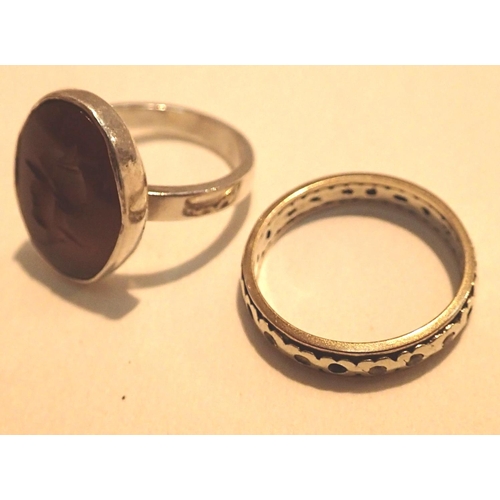 1076 - Two rings gold and silver eternity ring with wear and an orange stone intaglio ring. P&P Group 1 (£1... 