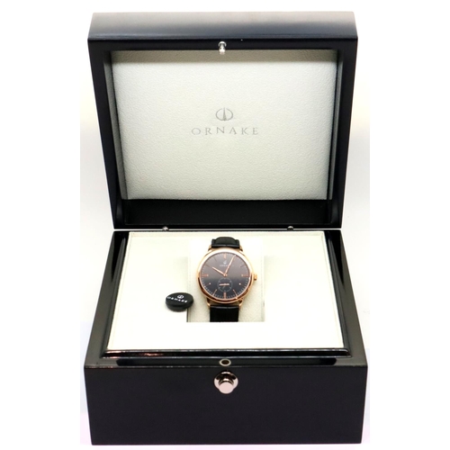 132 - New and boxed black face gold tone Ornake wristwatch with seconds dial and leather strap. P&P Group ... 