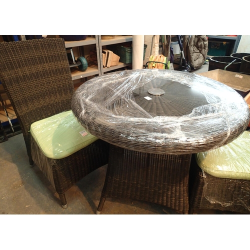 1510 - Black rattan circular table with tempered glass top and metal centerpiece. Two chairs with green cus... 