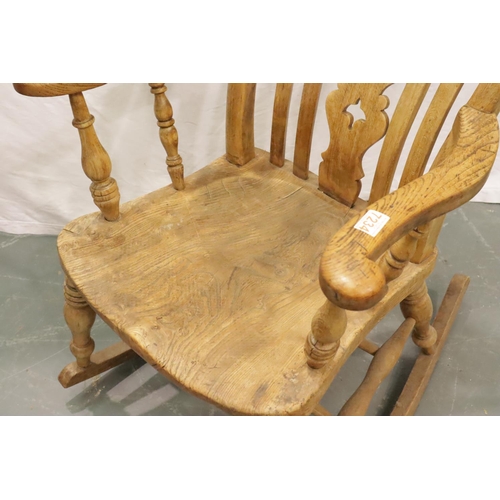 428 - Victorian farmhouse elm rocking chair with pierced backrest and turned elbow supports. Not available... 