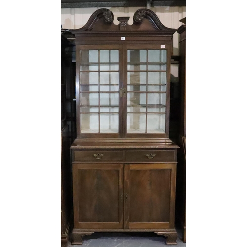 437 - Late Victorian walnut glazed bookcase, raised on a two drawer, two door cupboard base and Ogee carve... 