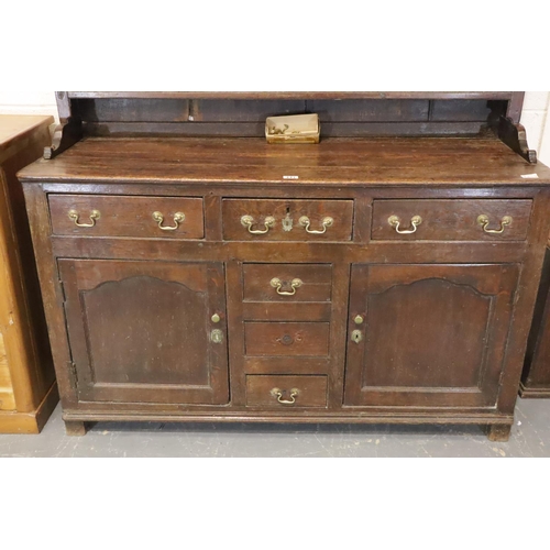 441 - George II oak dresser, the three shelf plate rack raised on a base of cupboards and drawers, 140 x 4... 