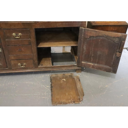 441 - George II oak dresser, the three shelf plate rack raised on a base of cupboards and drawers, 140 x 4... 