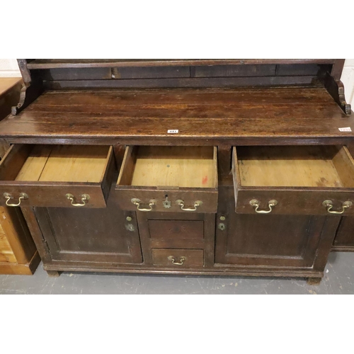 441 - George II oak dresser, the three shelf plate rack raised on a base of cupboards and drawers, 140 x 4... 