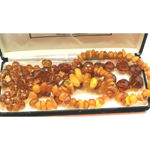 1085 - Two amber glass coloured necklaces, one with polished raw amber. P&P Group 1 (£14+VAT for the first ... 