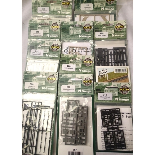 2306 - Twelve N gauge ratio trackside plastic kits, fencing, lamps, platform, canopy, footbridge, all in pa... 