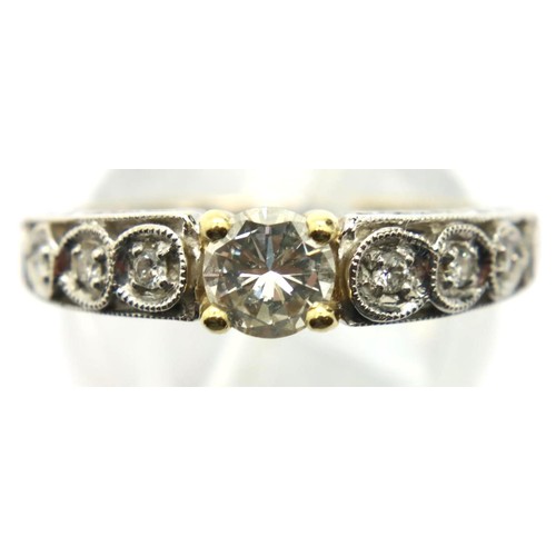 15 - A modern 18ct white and yellow gold solitaire diamond dress ring, the central stone of approximately... 