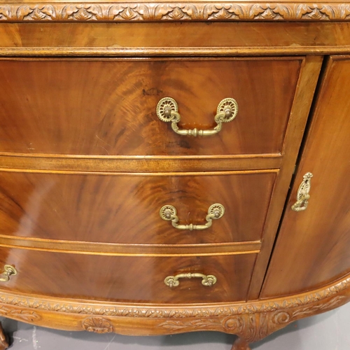 543 - A 20th century walnut three drawer, two door sideboard in the Epstein style, raised on claw and ball... 