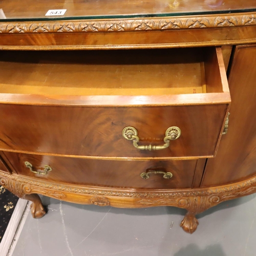 543 - A 20th century walnut three drawer, two door sideboard in the Epstein style, raised on claw and ball... 