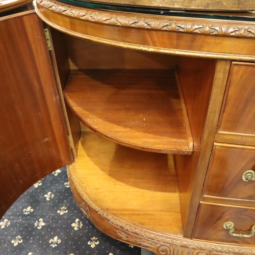 543 - A 20th century walnut three drawer, two door sideboard in the Epstein style, raised on claw and ball... 