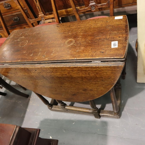 551 - An early 19th century country oak drop leaf table of small proportions. Not available for in-house P... 