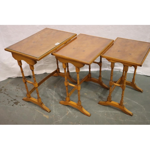 560 - Bevan Funnell for Reprodux a nest of three graduated occasional tables with glass tops, 51 x 36 x 56... 