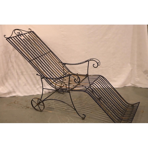 563 - An Edwardian wrought iron garden reclining chair, 54 x 190 x 75 cm H. Not available for in-house P&P... 