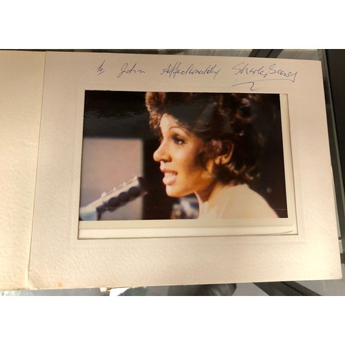 444 - Shirley Bassey, two publicity shot photographs in mounts, each signed and dedicated together with a ... 