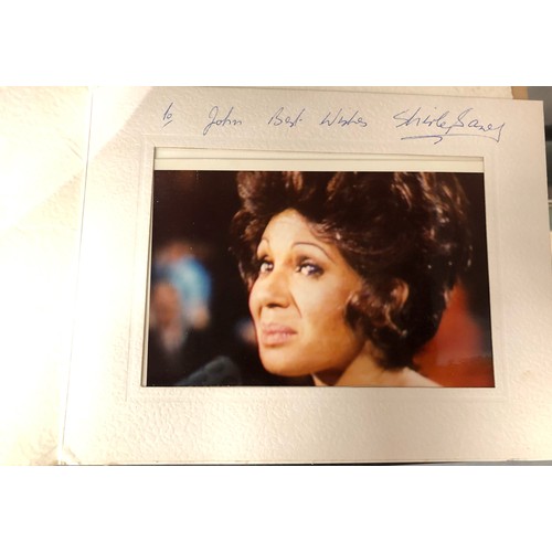 444 - Shirley Bassey, two publicity shot photographs in mounts, each signed and dedicated together with a ... 