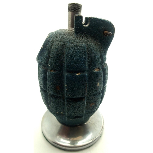 3155 - British WWII INERT Mills grenade, later converted to a perpetual table lighter, raised on a circular... 