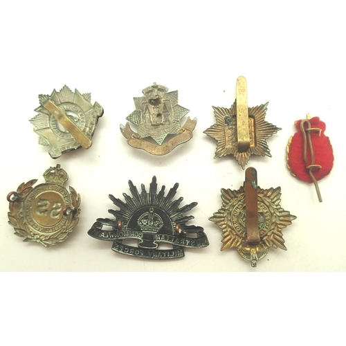 3179 - Six WWII British cap badges and an Australian Commonwealth Military Forces cap badge. P&P Group 1 (£... 