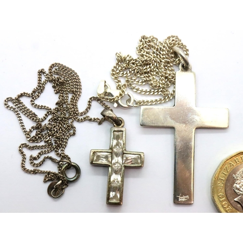 12 - Two silver crosses and chains, one stone set. P&P Group 1 (£14+VAT for the first lot and £1+VAT for ... 