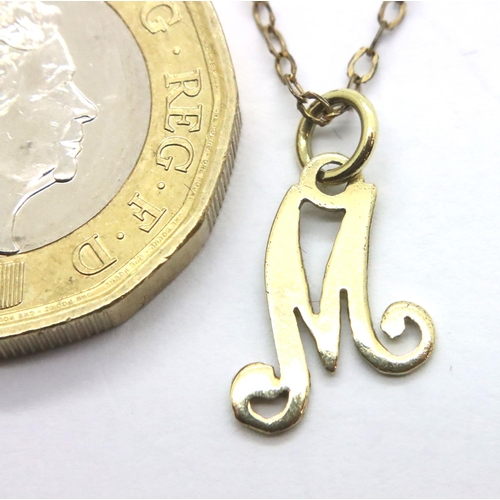 15 - 14ct gold letter M pendant on a 12ct gold chain, combined 1.3g. P&P Group 1 (£14+VAT for the first l... 