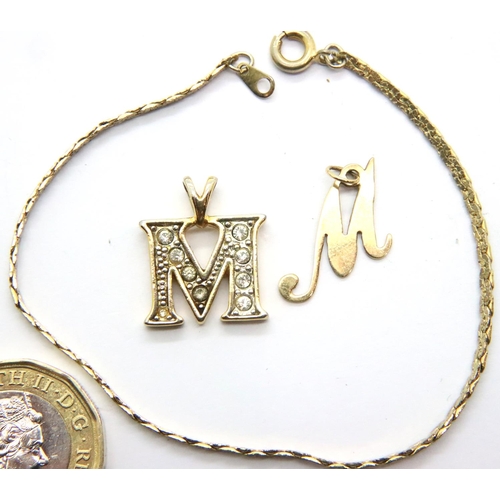 28 - 9ct gold letter M pendant, a further stone-set letter M pendant and a bracelet. P&P Group 1 (£14+VAT... 