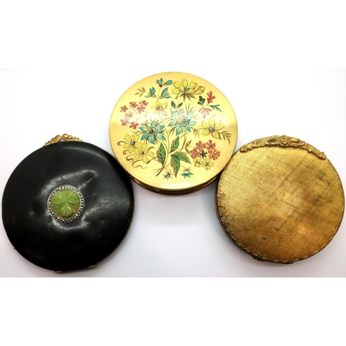113 - Three vintage compacts; one set with a carved jade panel and marcasite, two further examples, all un... 
