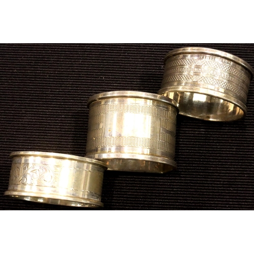 135 - Three vintage hallmarked sterling silver napkin rings, all with vacant cartouches, one Chester assay... 