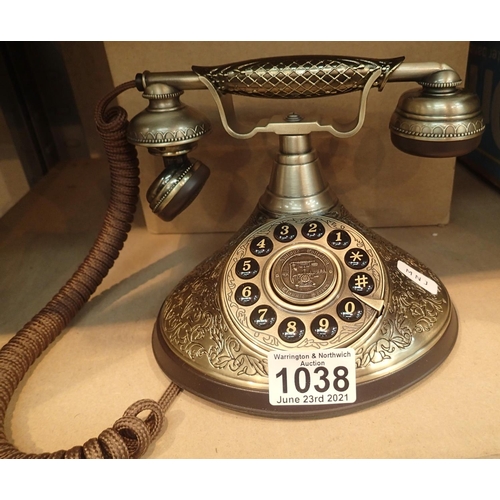 1038 - The Duchess; a push button telephone with a solid, brass finish and traditional cloth handset curly ... 