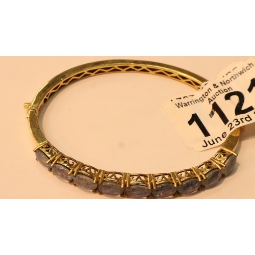 1121 - A gold coloured bangle set with nine opal type stones. P&P Group 1 (£14+VAT for the first lot and £1... 