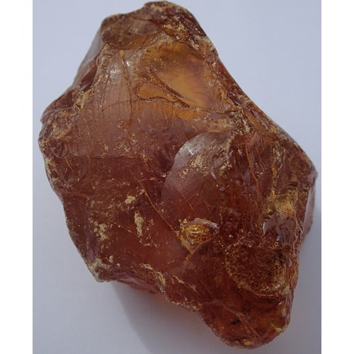 1112 - Large piece of unpolished amber coloured stone believed to be resinous amber, to weigh 58g. P&P Grou... 