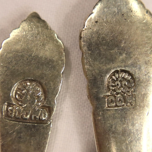 118 - A set of twelve continental 800 silver teaspoons with sugar spoon, each relief decorated and marked ... 