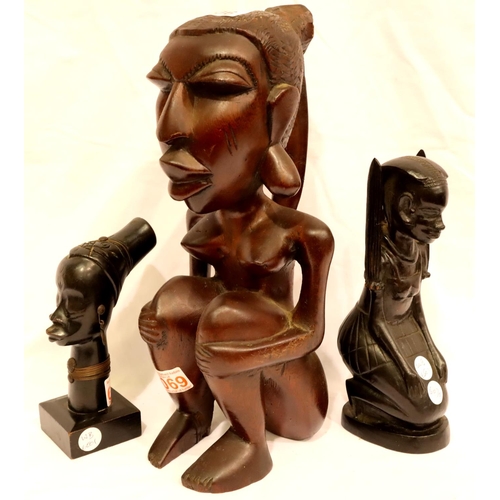 306 - One large and two smaller carved tribal figurines, tallest H: 34 cm. P&P Group 3 (£25+VAT for the fi... 