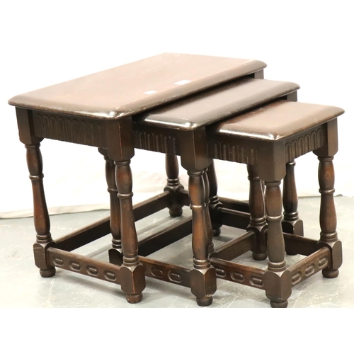 641 - An Ercol style nest of three dark elm graduated occasional tables. Not available for in-house P&P, c... 