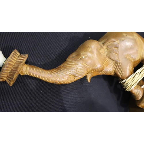 240 - A pair of mid 20th Century carved teak lamp bases in the form of elephants, each H: 34 cm (excluding... 