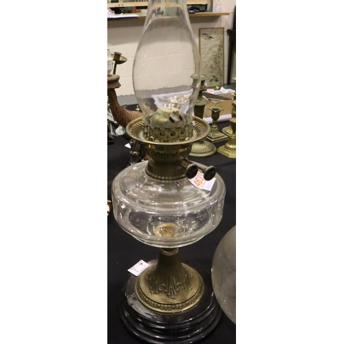 241 - A 19th century oil lamp , the brass and glass base supporting the clear glass reservoir duplex burne... 