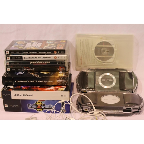 2243 - Sony PSP, two boxed handheld consoles in Logitech cases with a selection of games. P&P Group 2 (£18+... 