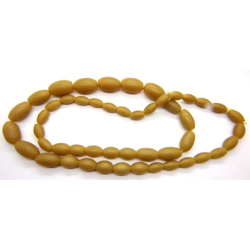 66 - Butterscotch amber bead necklace, L: 72 cm, largest bead: 31 mm. P&P Group 1 (£14+VAT for the first ... 