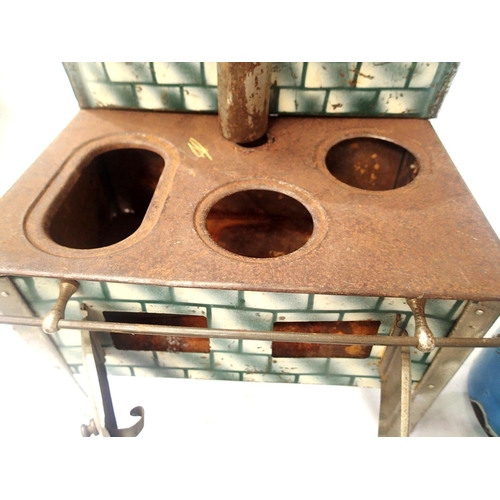 2076 - Tinplate toy stove, spirit fired, complete with pots, kettle etc, in fair to good condition, 20 x 14... 