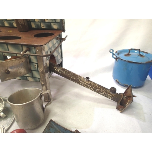 2076 - Tinplate toy stove, spirit fired, complete with pots, kettle etc, in fair to good condition, 20 x 14... 