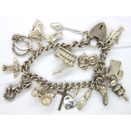 53 - Silver charm bracelet with eighteen charms, combined 48.5g. P&P Group 1 (£14+VAT for the first lot a... 