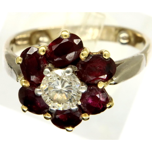 68 - 18ct gold diamond and ruby flower ring, size I, 3.7g. P&P Group 1 (£14+VAT for the first lot and £1+... 