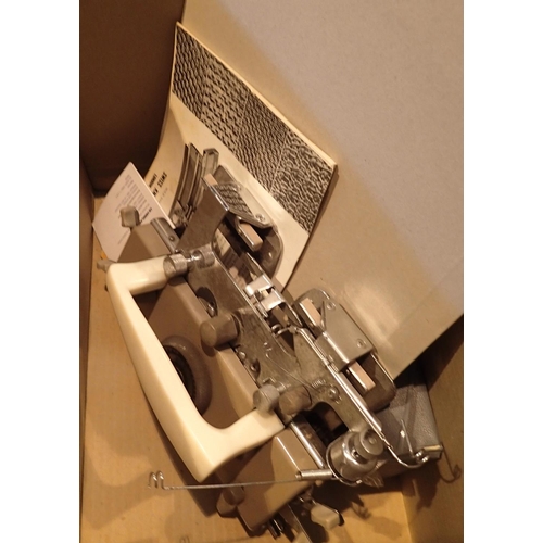 1766 - Boxed Vogue knitting machine in steel case with knitting patterns etc. Not available for in-house P&... 